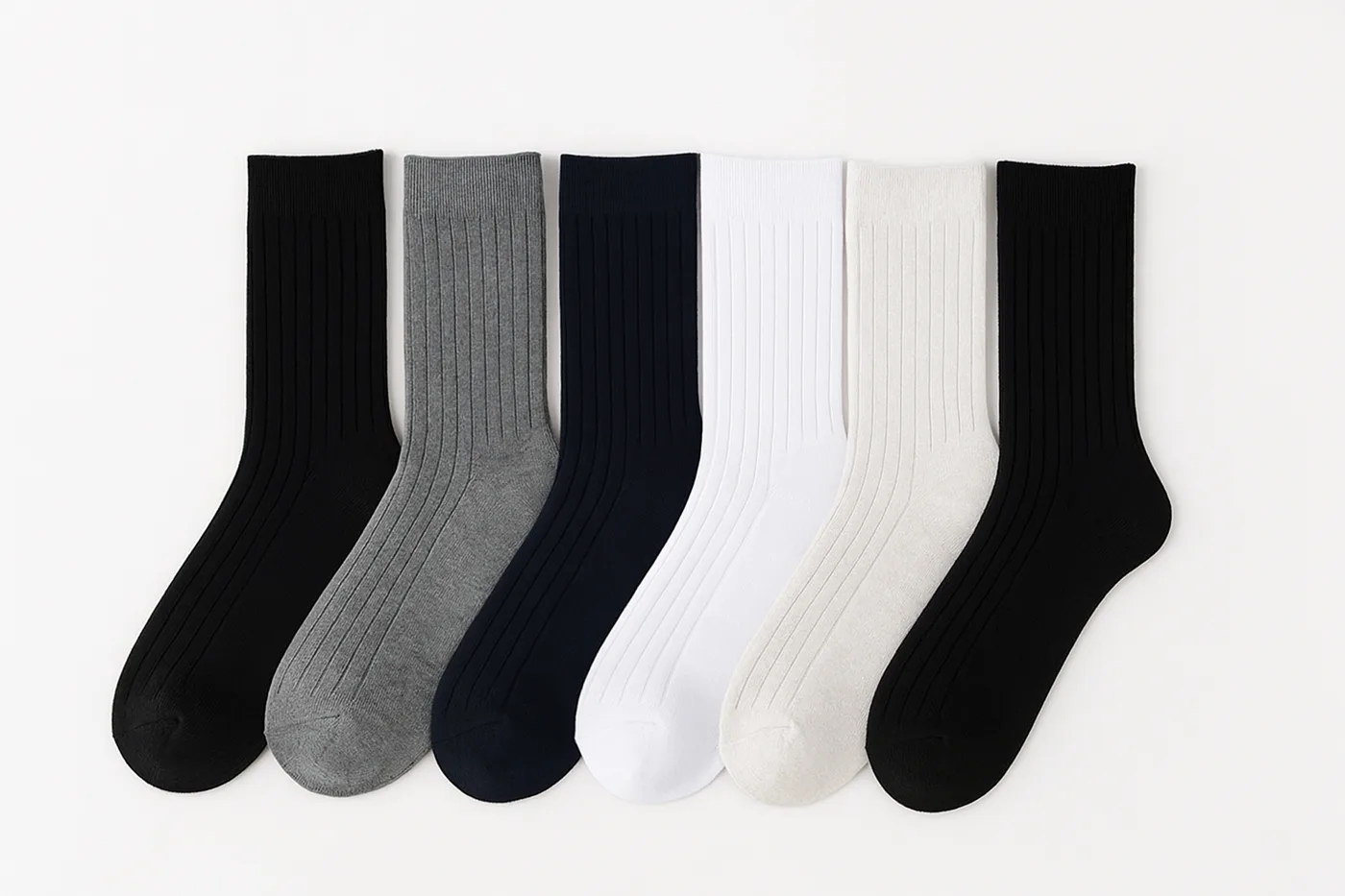 A flat-lay collection of crew socks in black, grey, navy and white